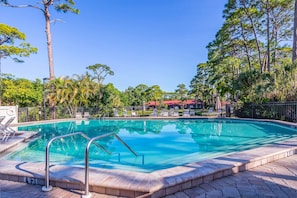 Large community heated pool with water views.