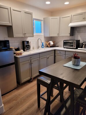 Kitchenette with microwave,  toaster oven, 2 burner stove and small fridge