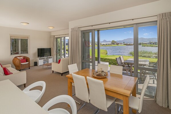 Open plan kitchen, dining and lounge, out on to two decks overlooking the lake,