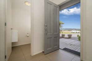 Front door, and secondary toilet. Looking out to parking and the golf course.