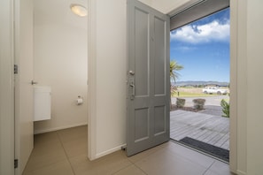 Front door, and secondary toilet. Looking out to parking and the golf course.