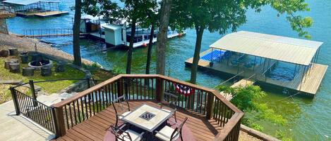 martini deck with beautiful cove views, concrete steps to dock, and a firepit