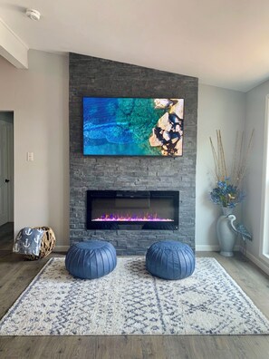 floor-to-ceiling stone fireplace w/insert, 60" Smart TV - YouTubeTV and HBO Max