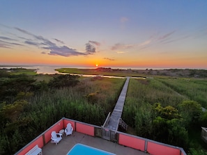 View from the third-floor deck of the pool, dock, and awesome sunset.