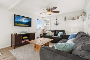 Living room, located right off the kitchen, standard couches (not sleeper sofas)