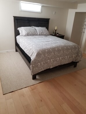 Master Bedroom (featuring walk in closet) and custom in walk shelving (65in TV) 