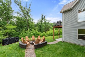 Gather under the stars at the cozy firepit with Adirondack seating.