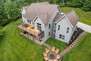 The house sits on 1.5 acres. Enjoy the firepit, hot tub, and grill.