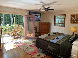 Listen to the sounds of nature in the master bedroom with French design doors.