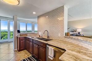 Sparkling Updated Kitchen with Quartz Countertop and Tile Backsplash