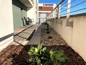 Spacious balcony with outdoor furniture. 