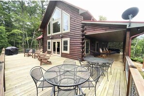 Wrap around deck with dining, multiple seating options, gas grill, and hot tub! 