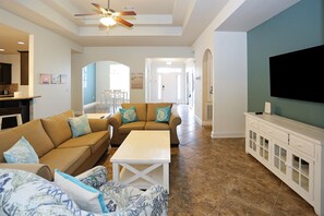 - Welcoming living room invites you to gather & unwind in style - Comfy sofas, coastal accents, & a view all the way to the front door create an airy, open feel - Perfect for reconnecting with loved ones after a beach day or enjoying a cozy movie night
