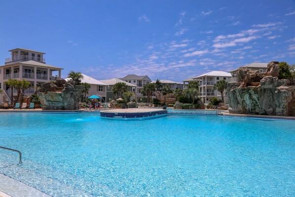 - Vacation mode with this massive lagoon style pool just steps from your door - Surrounded by tropical palms & dramatic rock features, it’s a true resort experience - Perfect for sun soaked afternoons, poolside lounging, & unforgettable family fun