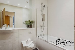 Family bathroom with shower over bathtub