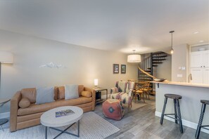 Open Living and Kitchen area with bar seating for 2 and dining table for 4.