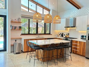 Full kitchen with olive oil, vinegar, salt, coffee & tea, sugar, and spices.