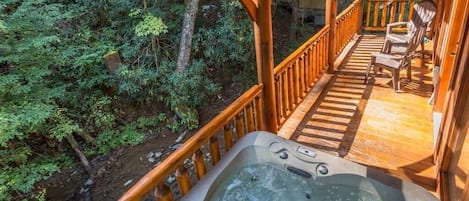 Hot tub on upper level deck overlooking the creek.