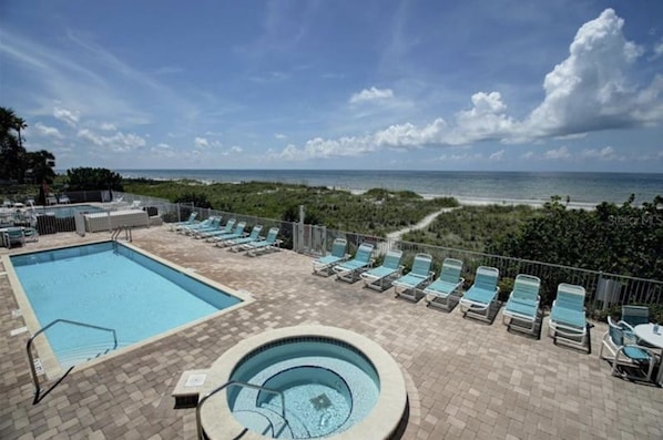 Heated pool and hot tub overlooks the glittering Gulf of Mexico
