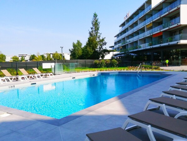 Lounge by the pool in the sunshine.