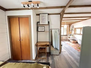 view of work desk and living area from bed