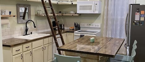 Kitchen.  Ladder can be removed.  Everyday needs are easily in reach on shelves.