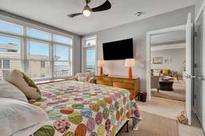 Wake up in this king bed to a beautiful bay view from the main bedroom