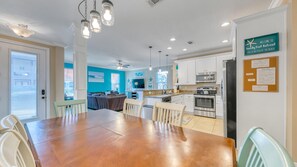 View of dining area, front door, kitchen and living room
