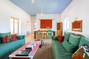 Living & dining room with 3 sets of French doors onto central courtyard