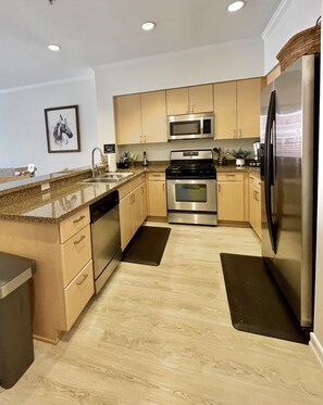 The full-sized kitchen with stainless steel appliances.