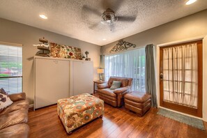 Comfy living room that opens up to covered patio.