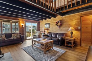Relax in the beautiful Living Area with high ceilings and hardwood flooring.
