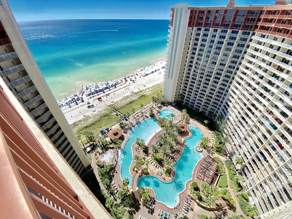 View of epic pool, tiki bar & grill, hot tub, and gulf from balcony