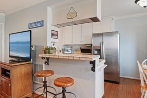 open kitchen with two barstools