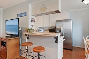 open kitchen with two barstools