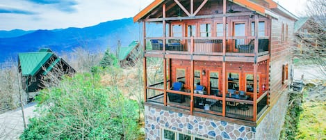 Enjoy spectacular mountain views from two large decks, firepit, comfy seating, hot tub and edison lights at night.