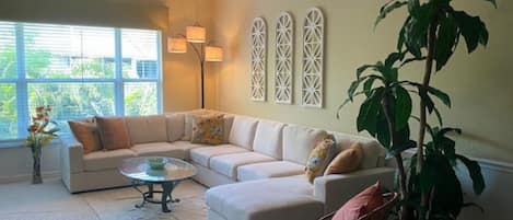 Spacious, cathedral ceiling living room with mounted TV