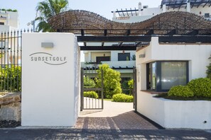 Gated entrance to the complex with security gard