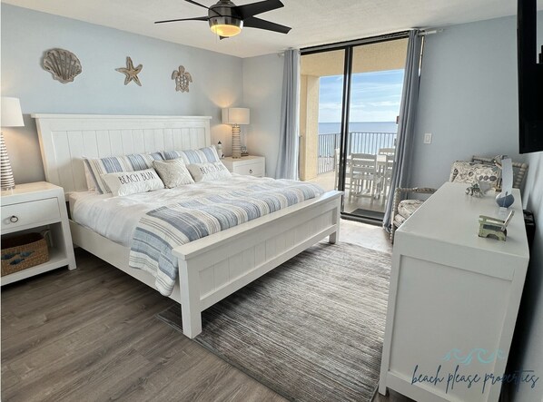 Master bedroom with king sized bed and private balcony access