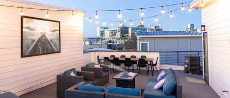 One of 4 private rooftops, each with movie projectors, outdoor dining and comfy seating!