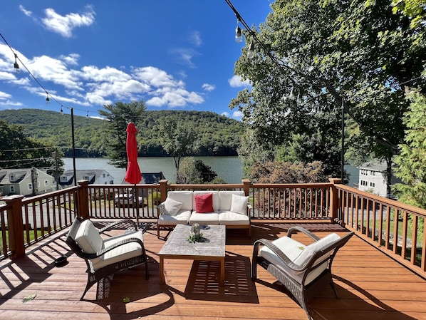 Main deck w/ grill & sweeping lake views. Baby/dog gate at deck stairs.