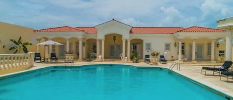 Large pool and home facade.