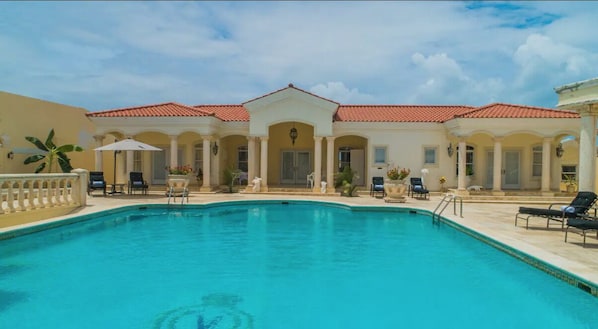 Large pool and home facade.