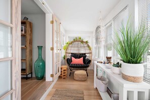 The closed in porch with comfy nest chair!