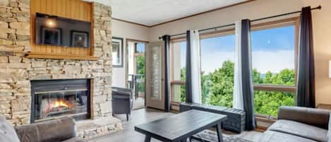 Living Room with Wood Burning Fireplace, Flat Screen RV and Large Windows