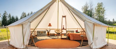 The beautiful Gypsy bell tent is a 20-footer decorated in coral and blue