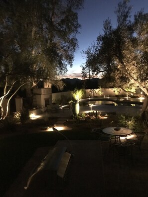 Professional landscaped setting with bubbling fountain  and night lighting.