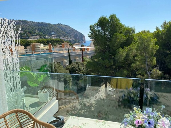 The large terrace overlooks the sea and the forests that surround Canyamel
