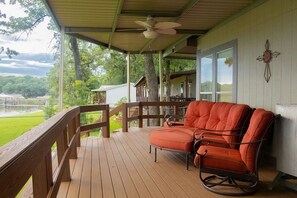 There are two large outdoor fans above the covered deck. 