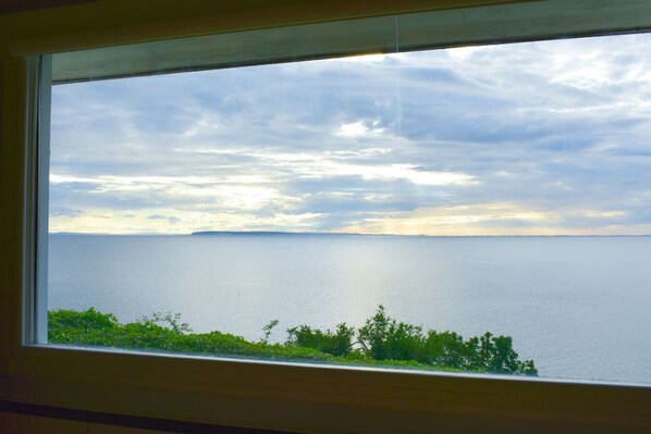 This 10' x 5' window frames what you will marvel at over and over - the ever changing water, movement of the sun and cloud formations. Sit and feel the expansion of your soul and the quieting of your mind.